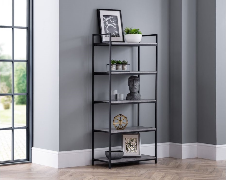 Tall concrete bookcase with a sleek black metal frame, featuring five open shelves, decorative items, and a modern design, set against a light gray wall.