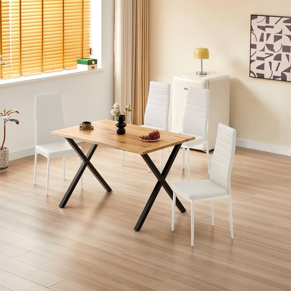 Kosy Koala wooden dining set featuring a brown tabletop with a sleek black frame and four white padded leather chairs, set in a bright, modern room with wooden flooring.