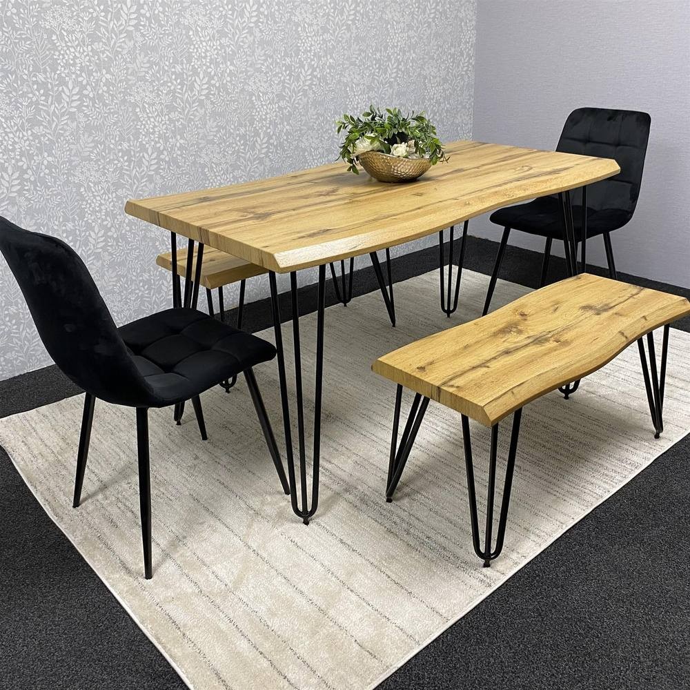 Modern dining table set featuring a brown wooden table with black metal legs, accompanied by two black velvet chairs and a matching bench, all on a light rug.