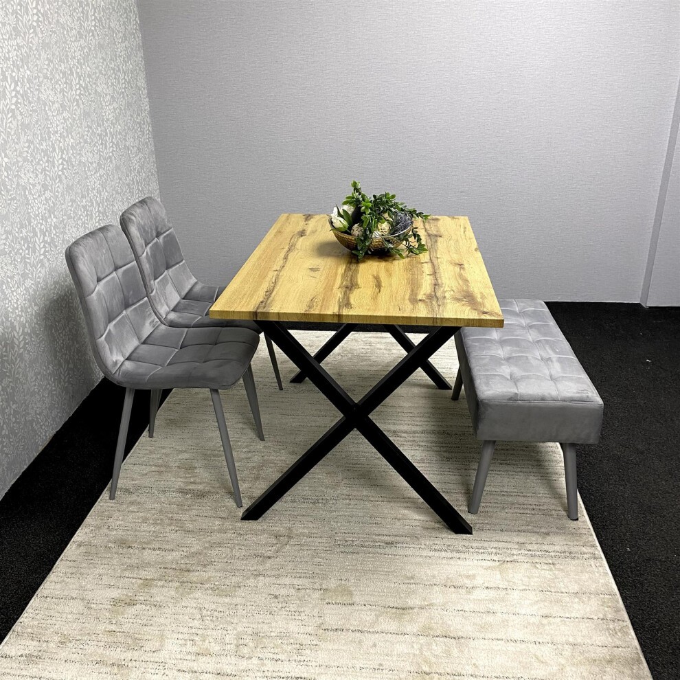 Modern dining table set featuring a brown wooden table with a black X-shaped base, accompanied by four grey upholstered chairs and a matching grey bench.