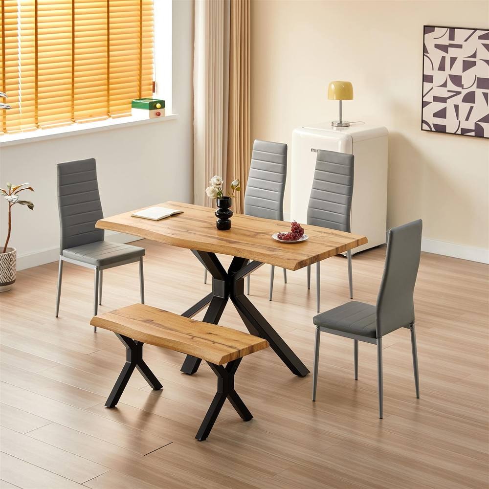 Kosy Koala wooden dining table in brown with a natural finish, accompanied by four grey upholstered chairs and a matching bench, set in a bright, modern kitchen space.