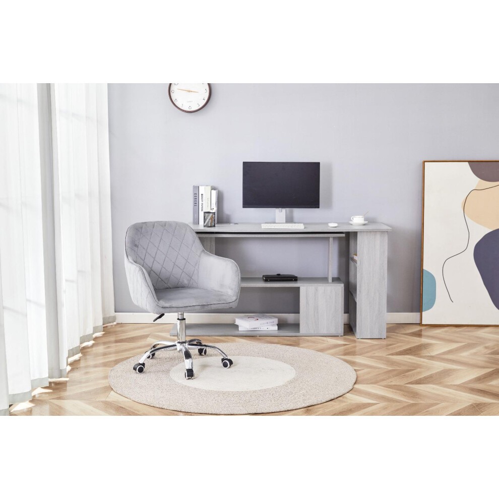 Grey office desk with a matching grey velvet upholstered chair featuring diamond stitching, alongside a drawer unit, set on a light wood floor with a round rug.