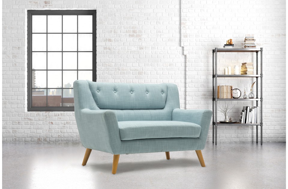 Pale blue fabric 2-seater sofa with wood legs, featuring a retro design and button-tufted backrest, set against a bright, modern interior with a bookshelf.