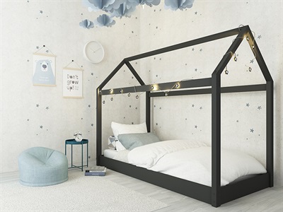 Black hickory wooden single bed with a house-shaped frame, featuring decorative lights, soft white bedding, and a light blue bean bag in a playful, starry-themed room.