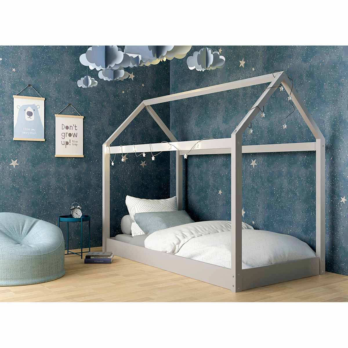 Grey wooden single bed with a house-shaped frame, featuring a slatted design, placed in a cozy room with starry wallpaper and a soft bean bag.