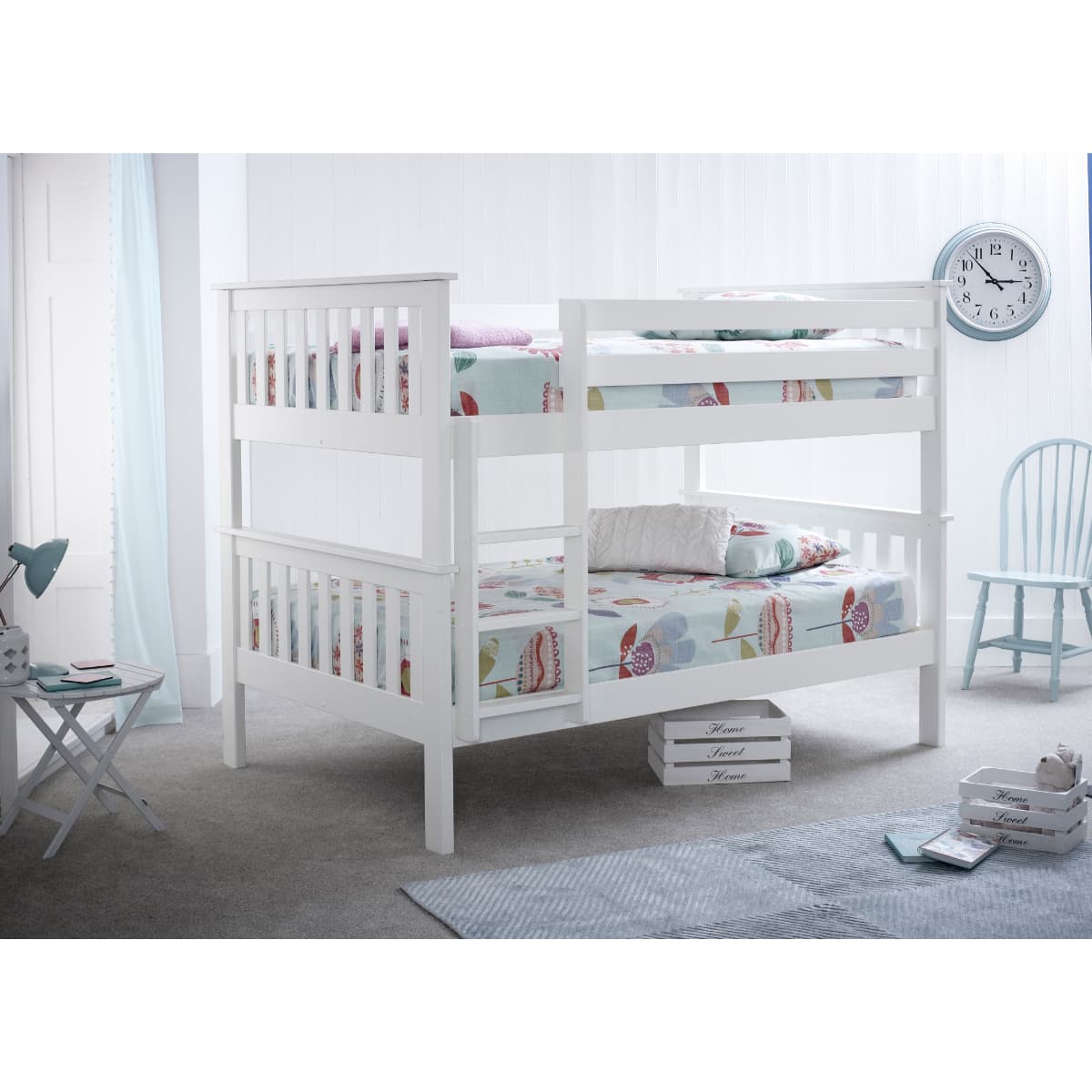 White quadruple bunk bed with memory foam mattresses, featuring a sturdy wooden frame, slatted design, and colorful patterned bedding in a bright, airy room.