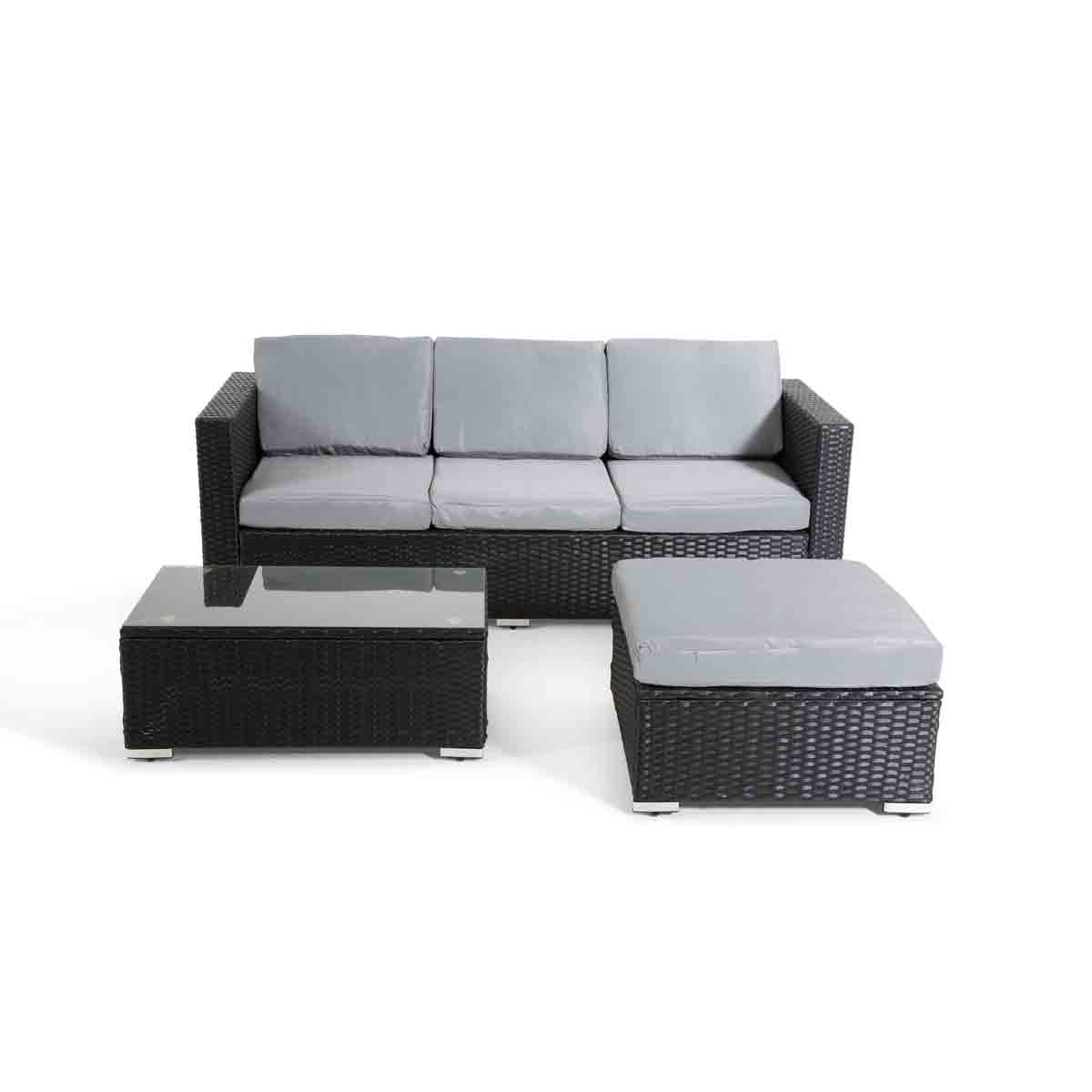 Stylish four-seat corner rattan set in black with gray cushions, featuring a glass-topped coffee table and a matching ottoman for outdoor relaxation.