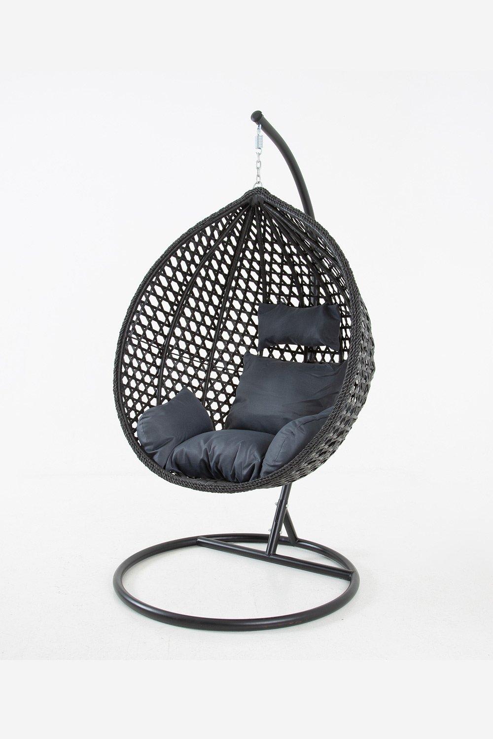 Black hanging swing pod chair made of woven material, featuring plush black cushions and a sturdy metal stand with a sleek, modern design. Includes a free protective cover.