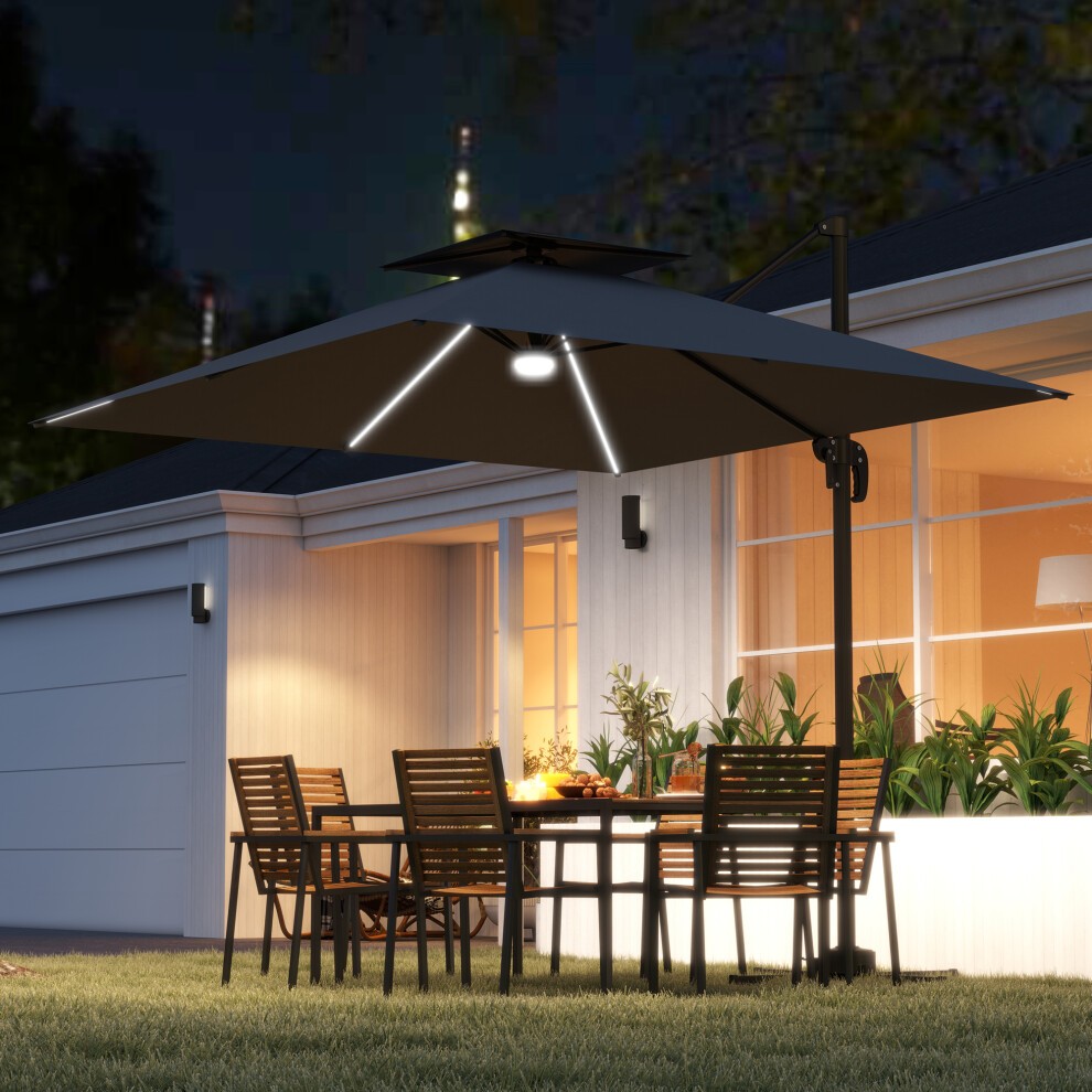 Grey 2.5m cantilever parasol with integrated lights, featuring a sturdy black frame, positioned over a dining table with wooden chairs in a garden setting at night.