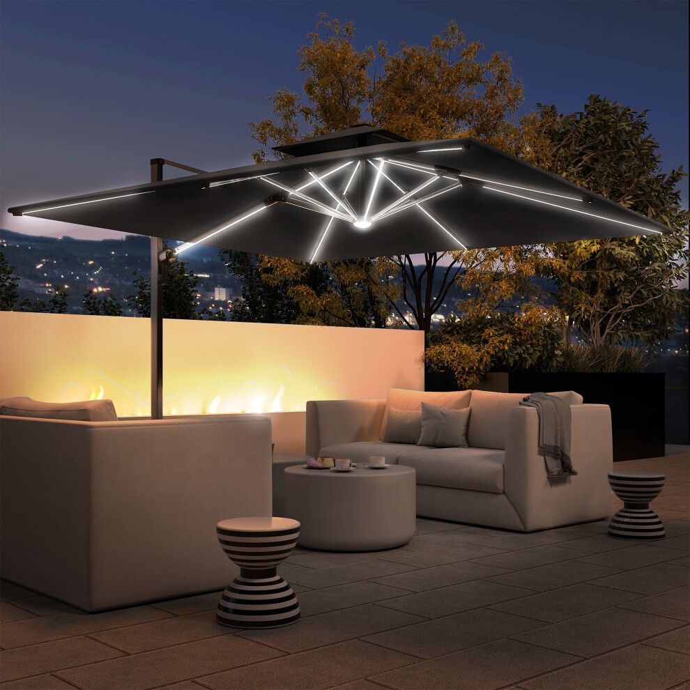 Grey cantilever parasol with solar LED lights, set over a modern outdoor seating area featuring white sofas and a round table, illuminated against a nighttime backdrop.