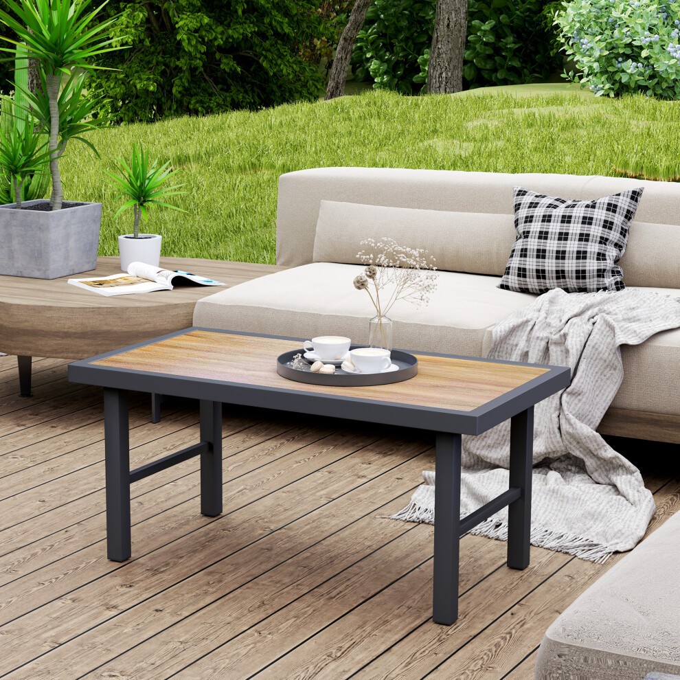 Brown wood-effect coffee table with SPC woodgrain tabletop, featuring a sleek design and sturdy black metal legs, set in a garden environment with greenery and outdoor furniture.