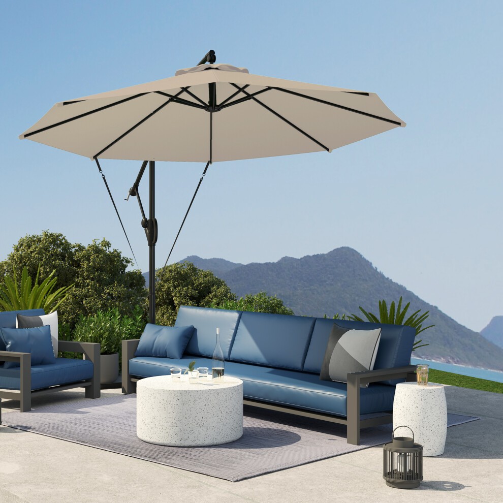 Khaki cantilever banana parasol with a sturdy black frame, featuring a wind strap and UPF50+ protection, positioned over a modern outdoor seating area with blue cushions.