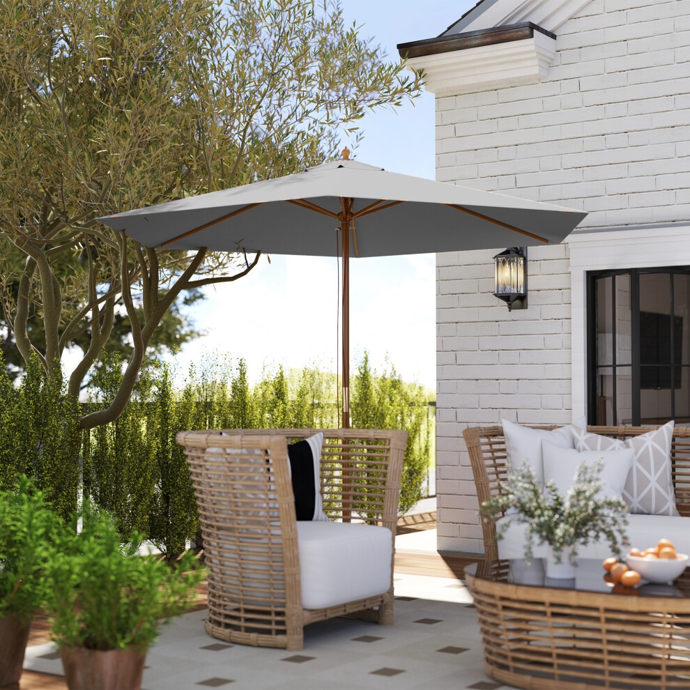 Grey wooden garden parasol with a square canopy, supported by a sturdy wooden frame, positioned over a stylish outdoor seating area with wicker furniture and decorative cushions.