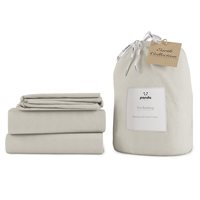 Coconut white super king bedding set made from bamboo and French linen, featuring a soft, smooth texture with neatly folded sheets and a tied storage bag.