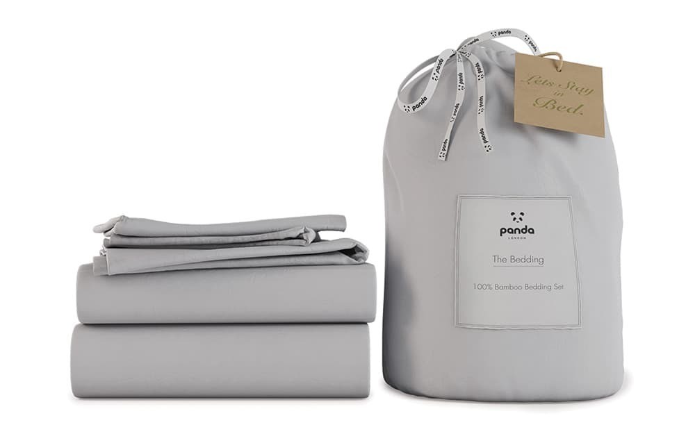 Pure white bamboo bedding set by Panda, featuring a soft, smooth texture, includes a fitted sheet, flat sheet, and pillowcases, packaged in a stylish drawstring bag.