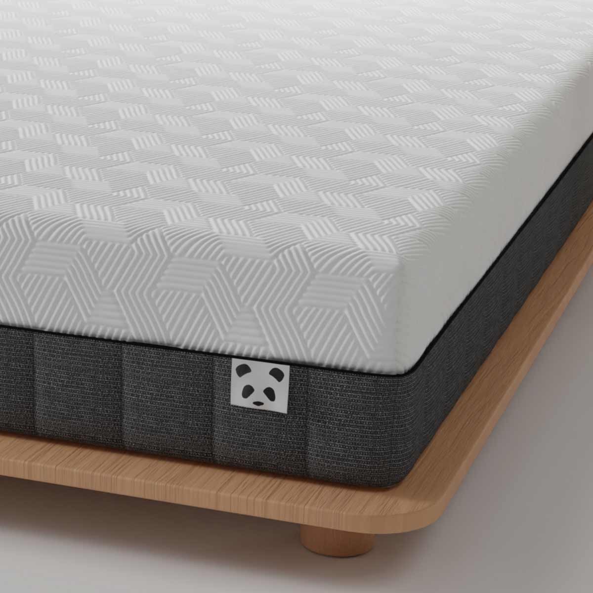 White hybrid bamboo mattress with a textured hexagonal pattern on top, dark grey sides, and a wooden base, featuring a small panda logo on the corner.