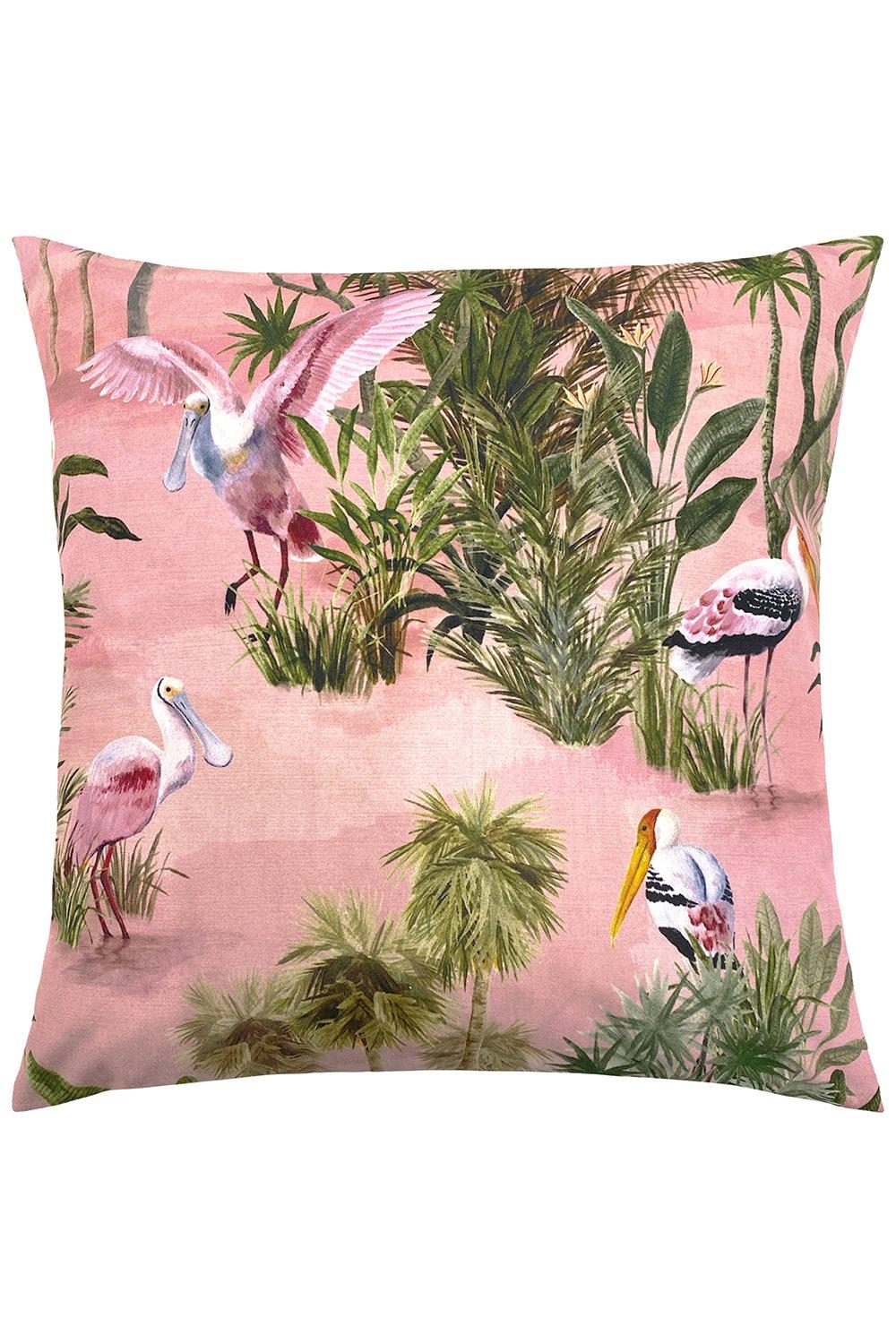 Pink outdoor cushion featuring tropical foliage and birds, made from water and UV-resistant material, designed for durability in outdoor settings.