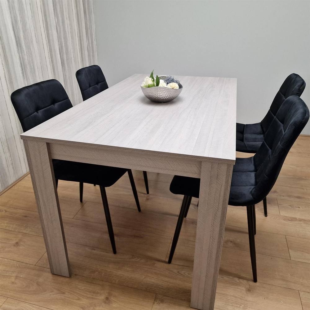 Grey dining table set featuring a rectangular table with a light wood finish and four black upholstered chairs with tufted backs, arranged on a wooden floor.