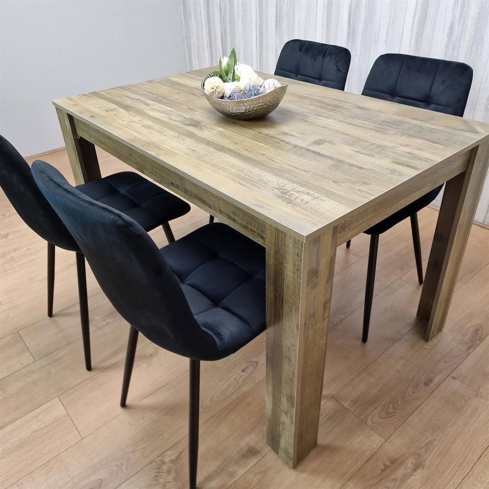 Brown wooden dining table with a textured finish, accompanied by four black upholstered chairs featuring tufted backs, set in a modern dining space.