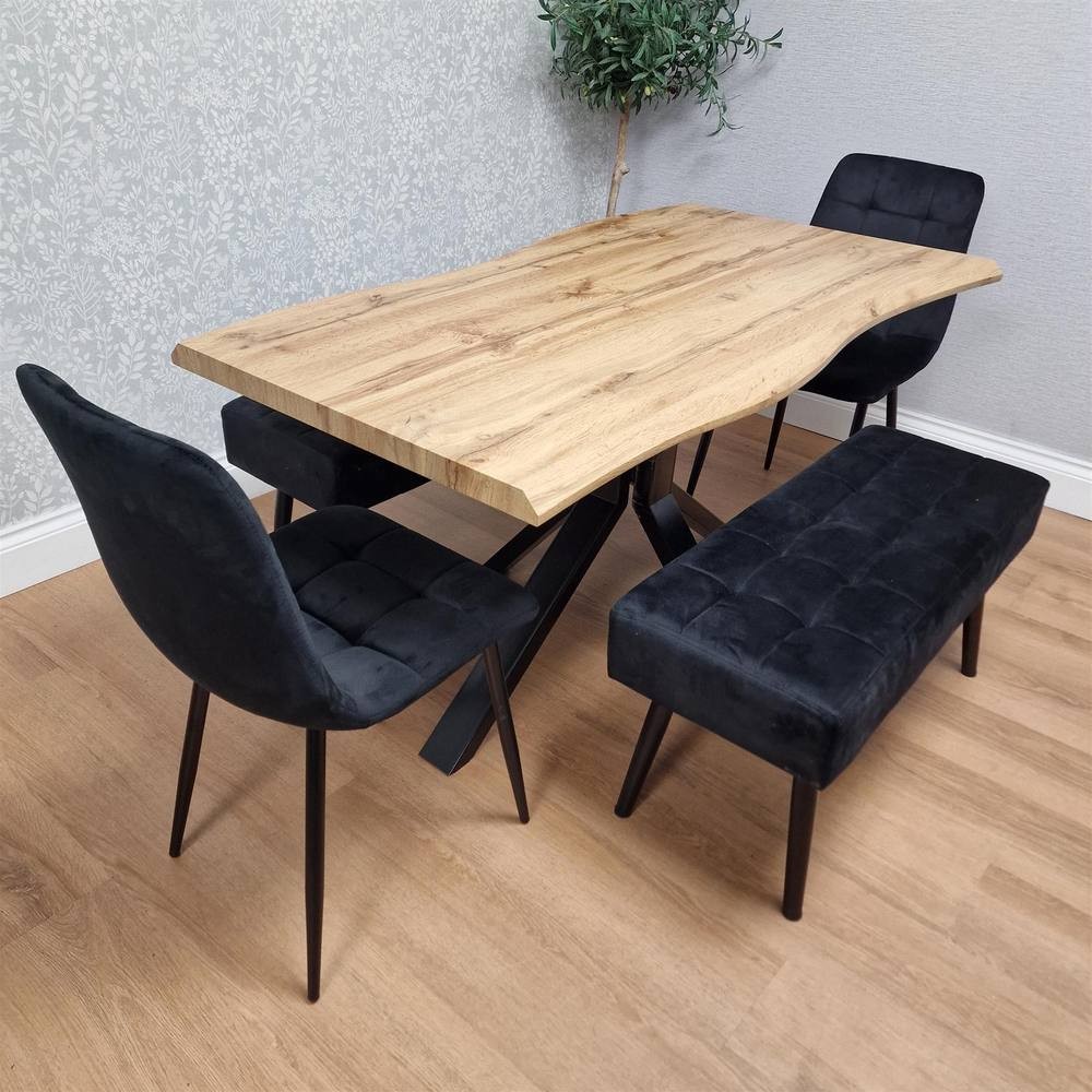 Kosy Koala dining table set featuring a natural wood tabletop with a live edge, accompanied by two black velvet chairs and two black tufted benches on a light wood floor.