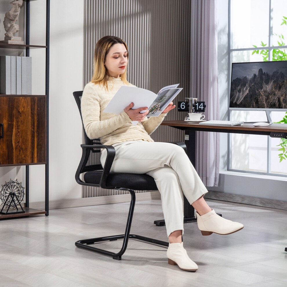 Black mesh office chair with a sled base, featuring a modern design, placed in a bright office setting with a person reading documents.