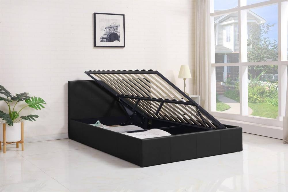 Grey leather ottoman bed with gas lift storage, featuring a black pine wood frame and slatted base, set in a bright room with natural light and a plant nearby.