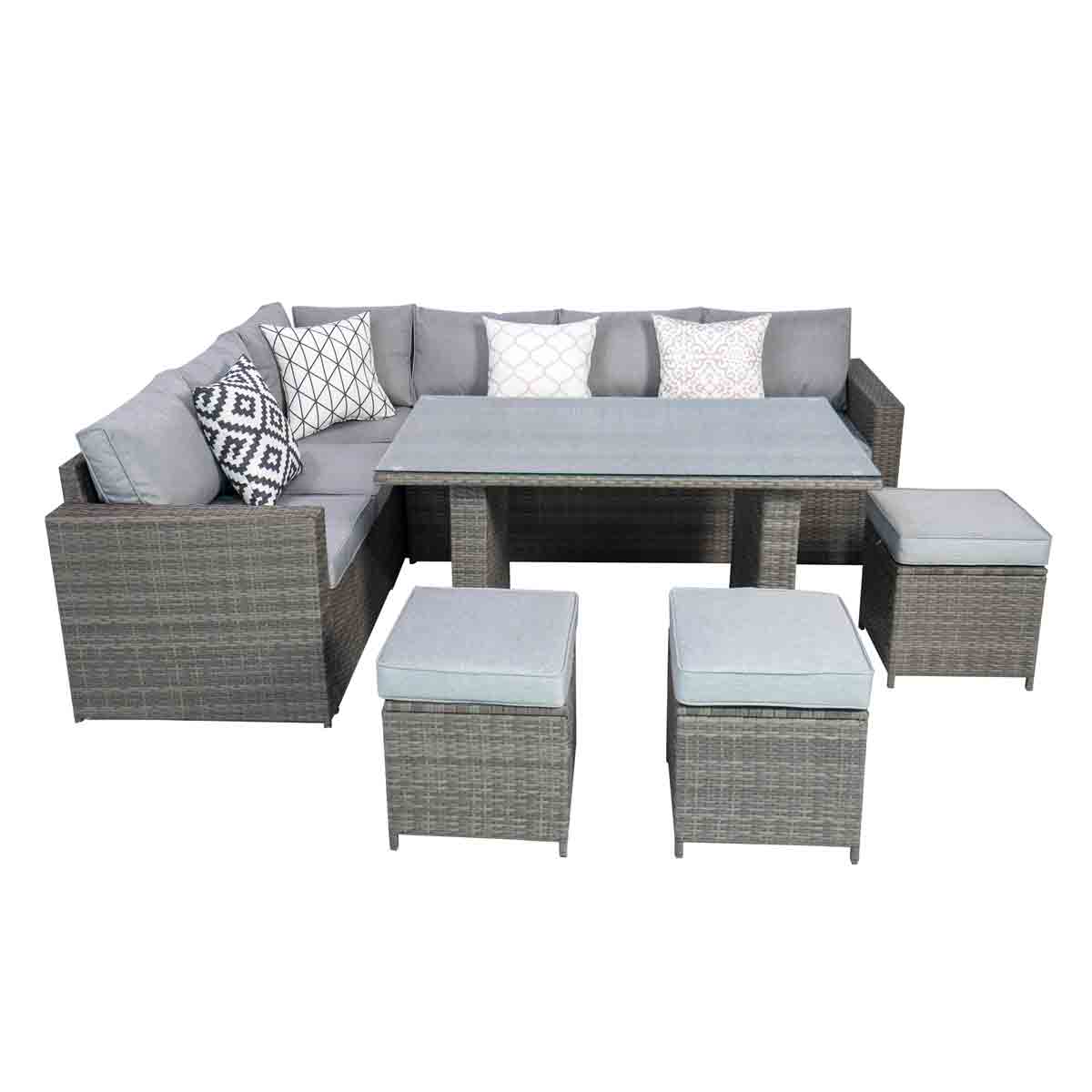Grey rattan 6-seat corner set with high table, featuring plush grey cushions and decorative pillows, complemented by two matching ottomans.