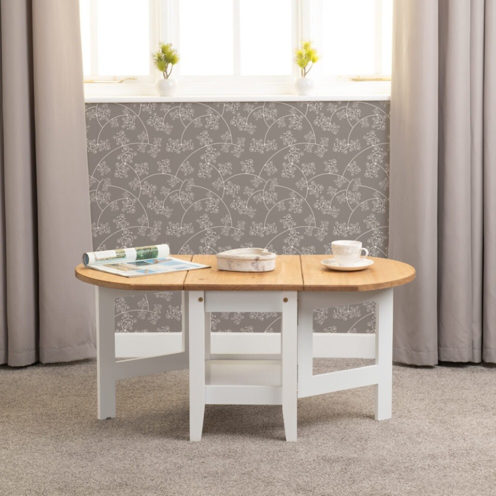Santos Drop Leaf Coffee Table features a natural wood top with a light oak finish and a white painted base, designed with two drop leaves and a modern, minimalist style.