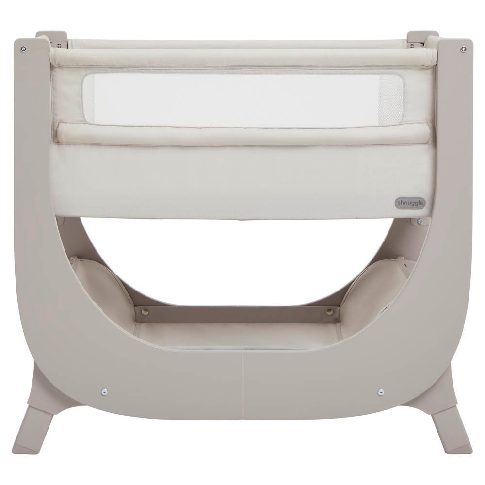 Taupe bedside bassinet with a height-adjustable frame, soft fabric sides, and a cushioned mattress, designed for infants with a modern, sleek look.