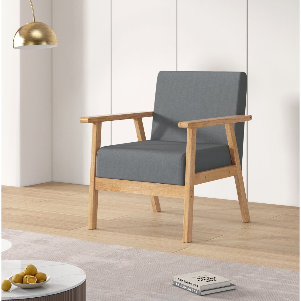 Grey linen accent chair with wooden frame and armrests, featuring a minimalist design, set against a light-colored wall and wooden floor.