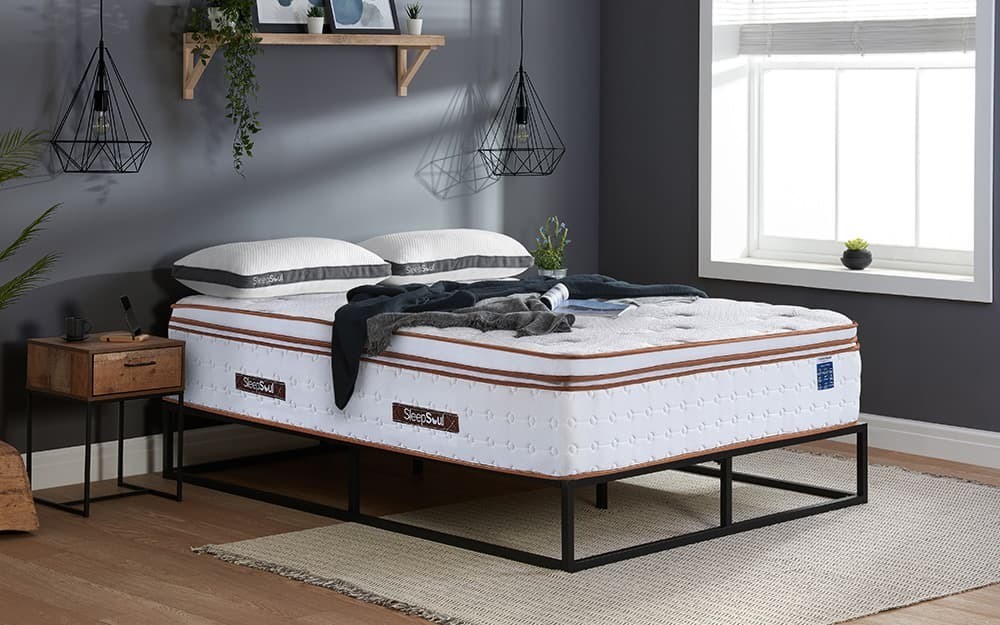Birlea SleepSoul Space 3000 double mattress features a white memory foam and pocket sprung design, with a textured surface and brown detailing, placed on a modern black metal frame.