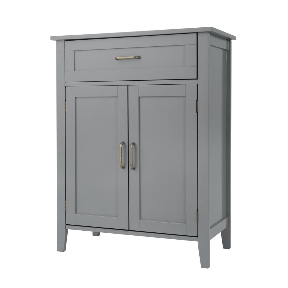 Mid-century modern wooden floor storage cabinet in a soft gray finish, featuring a single drawer and double doors with brass handles, set on tapered legs.