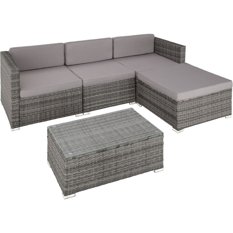 Grey poly-rattan garden furniture set featuring a sectional sofa with plush grey cushions and a matching glass-top coffee table.