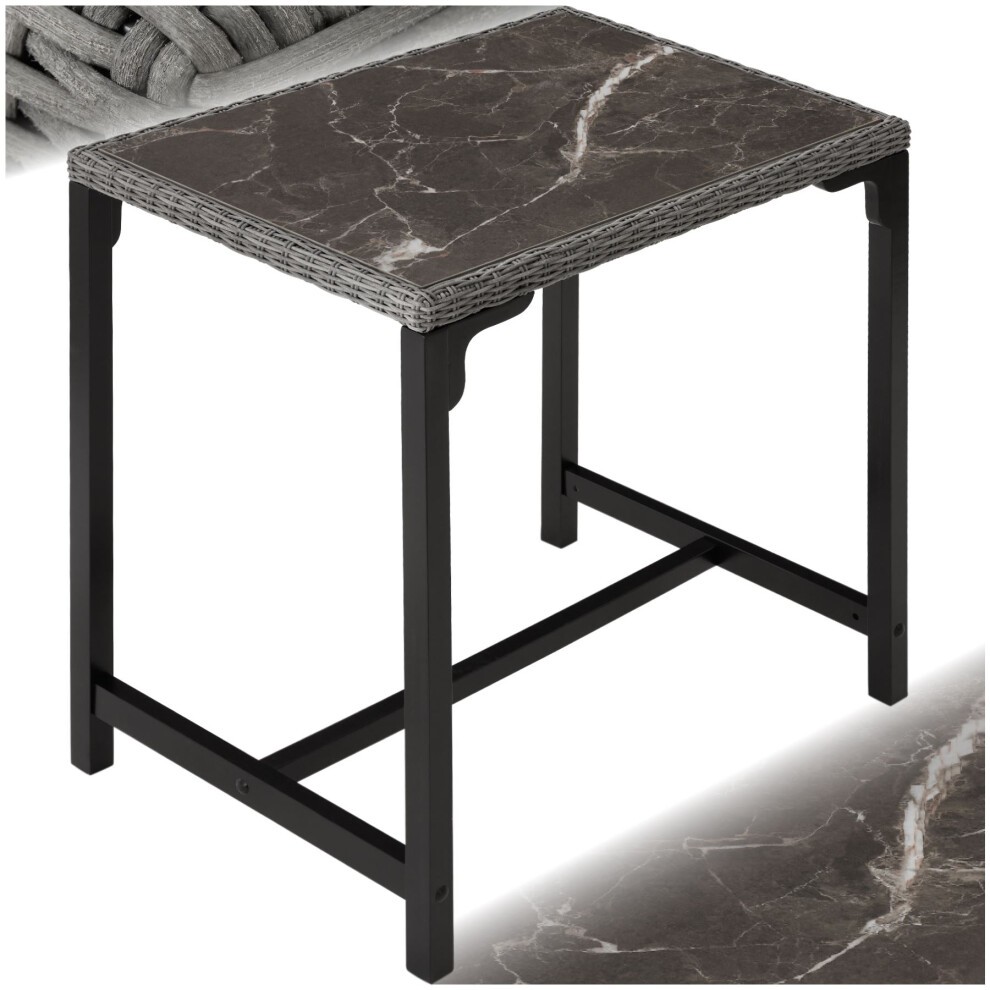 Grey dining table with a marble-like top and rattan detailing, featuring a sturdy black metal frame, ideal for outdoor patio or garden use.