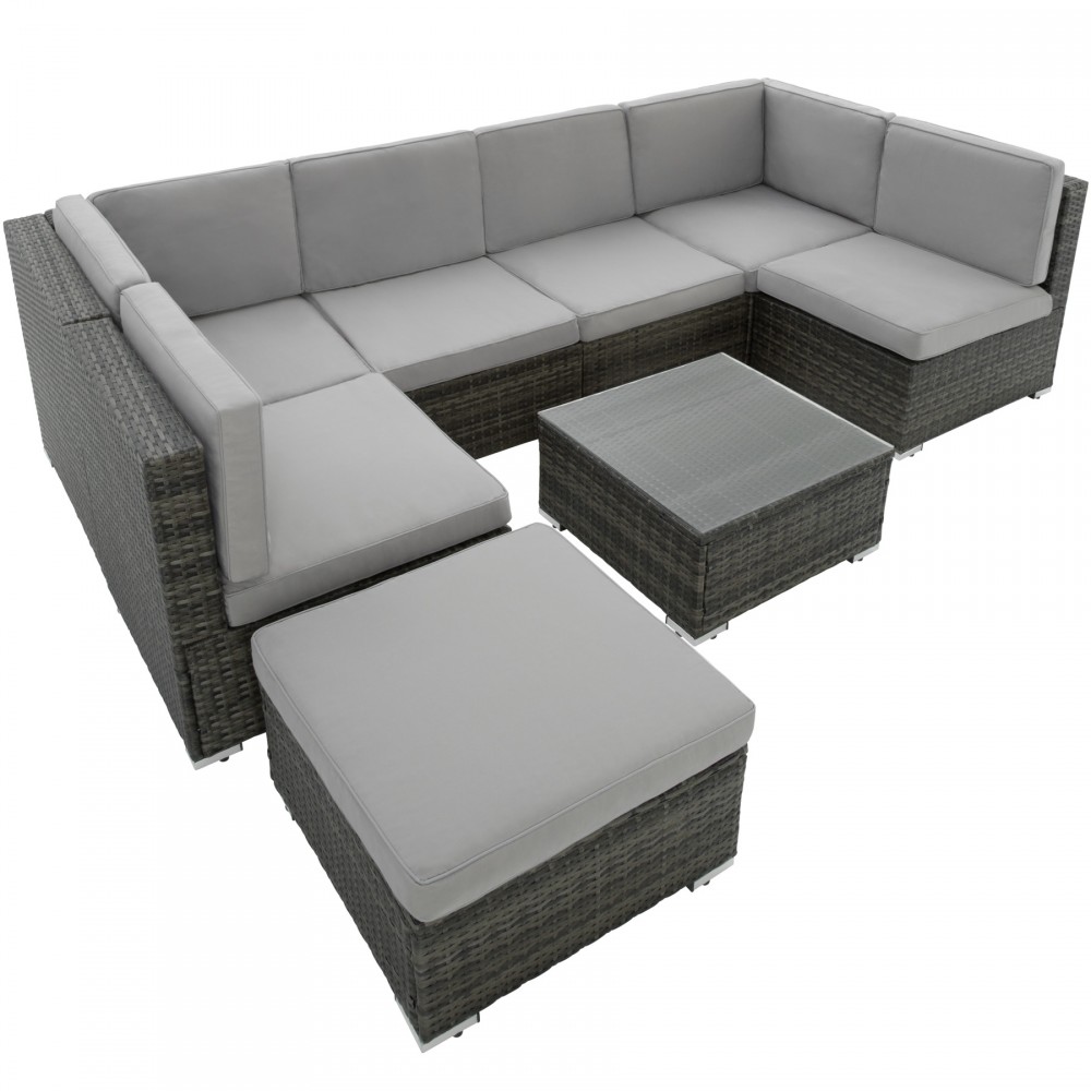 Dark grey rattan garden lounge set with grey cushions, featuring a sectional sofa, a square coffee table with a glass top, and a matching ottoman.