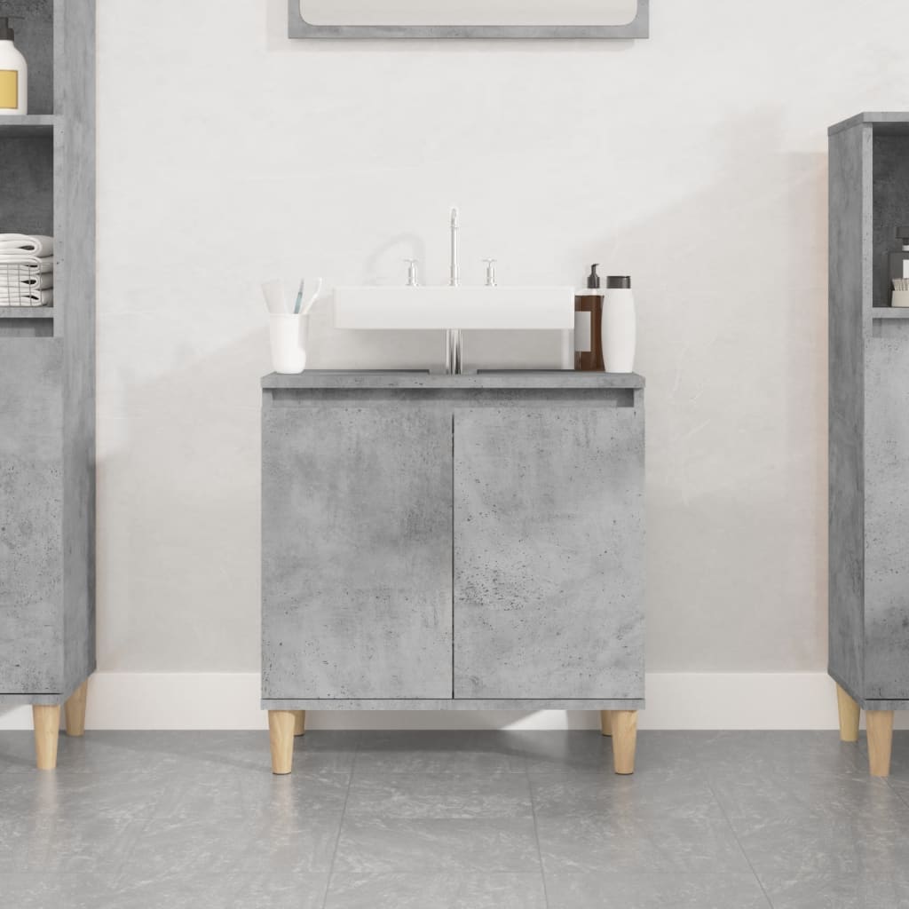 Concrete grey sink cabinet made of engineered wood, featuring two doors, wooden legs, and a white sink on top, set against a minimalist background.