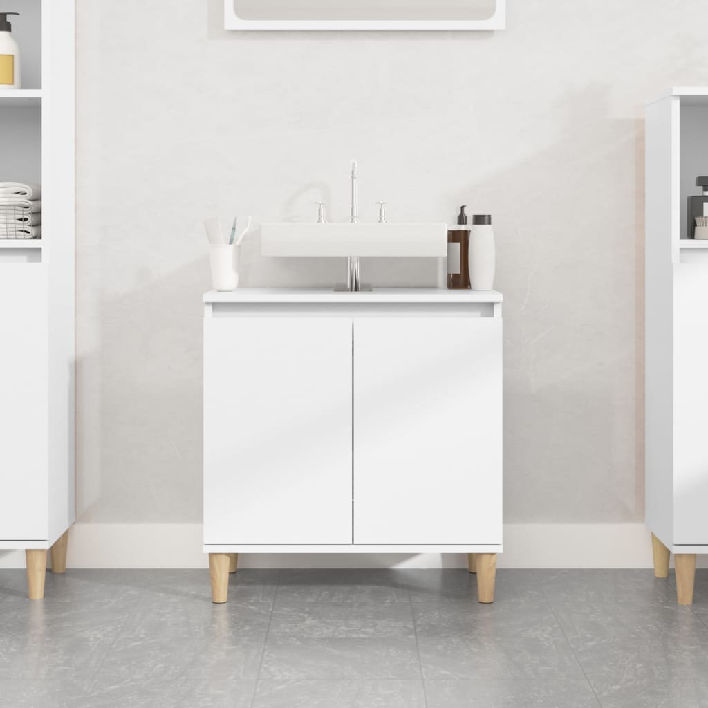 White sink cabinet made of engineered wood, featuring two doors, wooden legs, and a modern design, measuring 58x33x60 cm, with a sleek sink on top.