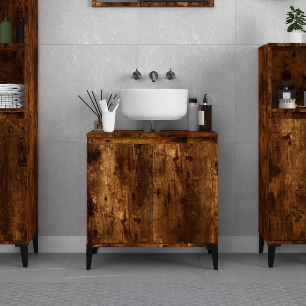 Smoked oak sink cabinet with engineered wood, featuring a white basin, sleek black legs, and a modern design, set against a neutral tiled wall.