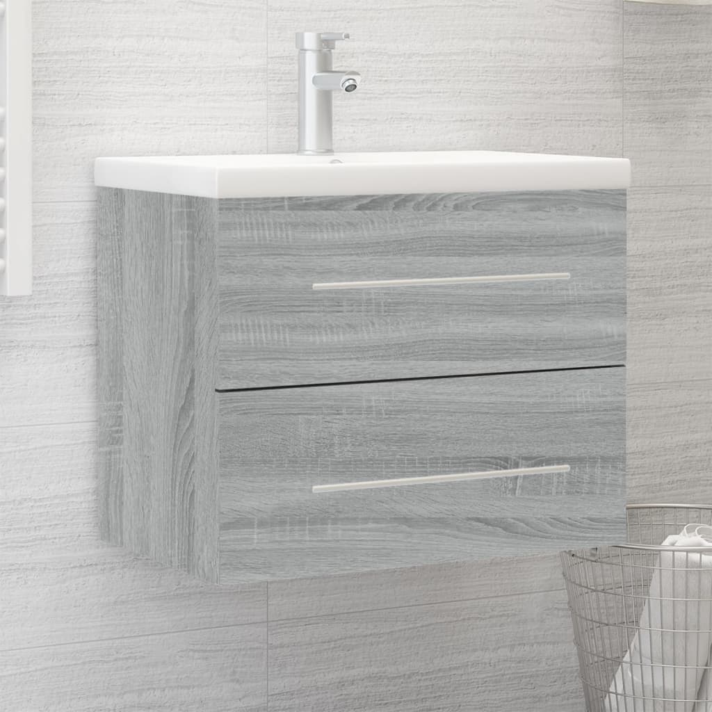 Grey Sonoma engineered wood sink cabinet featuring a built-in white basin, two drawers with sleek silver handles, mounted against a textured wall.