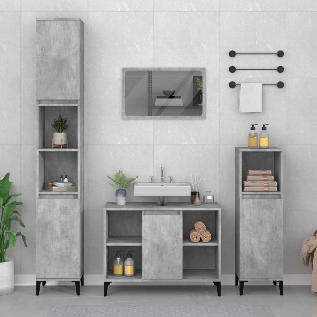 Concrete grey sink cabinet made of engineered wood, featuring two doors, open shelves, and sleek black legs, complemented by matching tall storage and wall-mounted accessories.