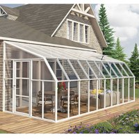 Clear sunroom with white frame, sloped roof, and glass panels attached to a house, featuring a door and patio setup.