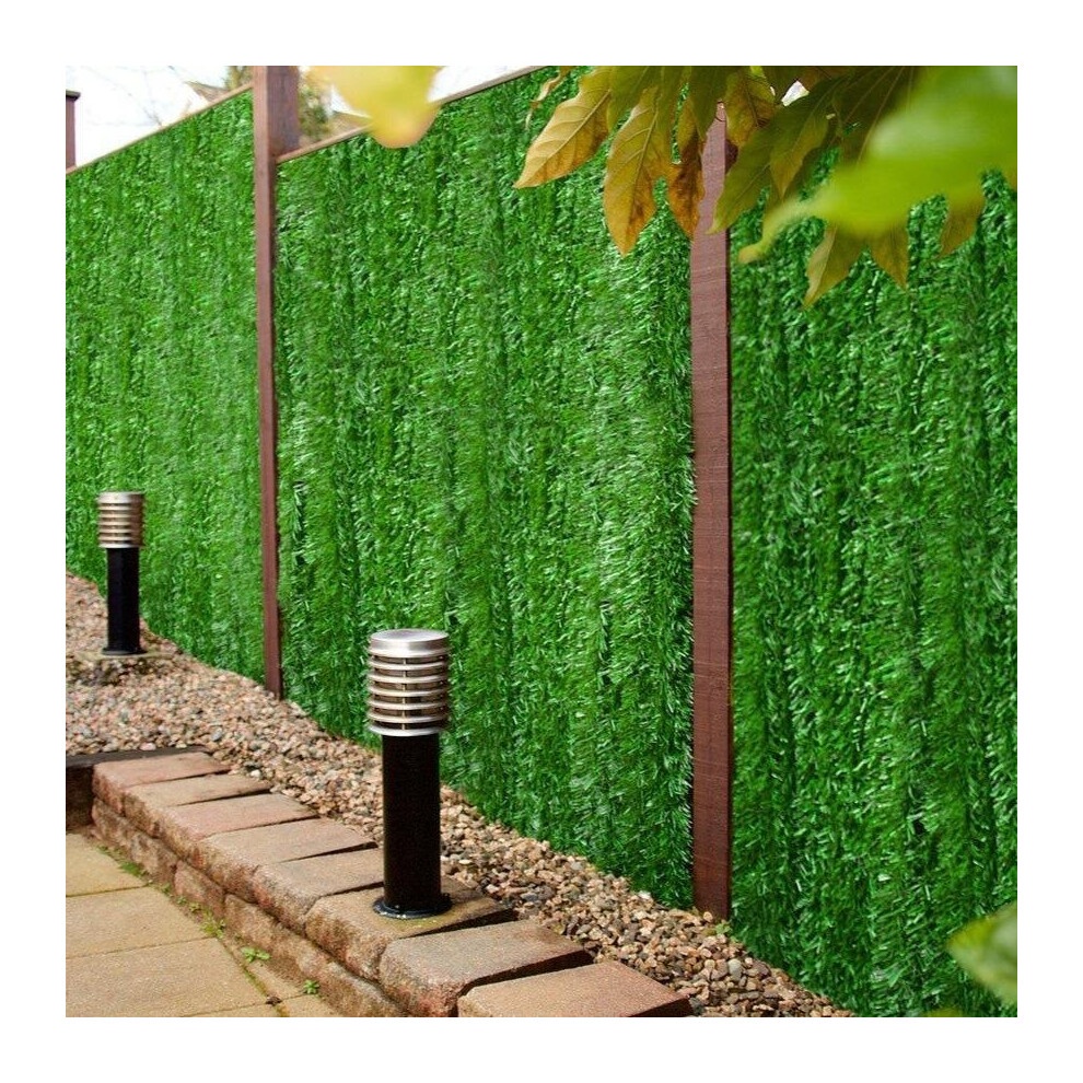 Artificial conifer leaf screening hedging in vibrant green, measuring 3m x 1m, features a textured, realistic foliage design, set against a stone pathway and metal post lights.