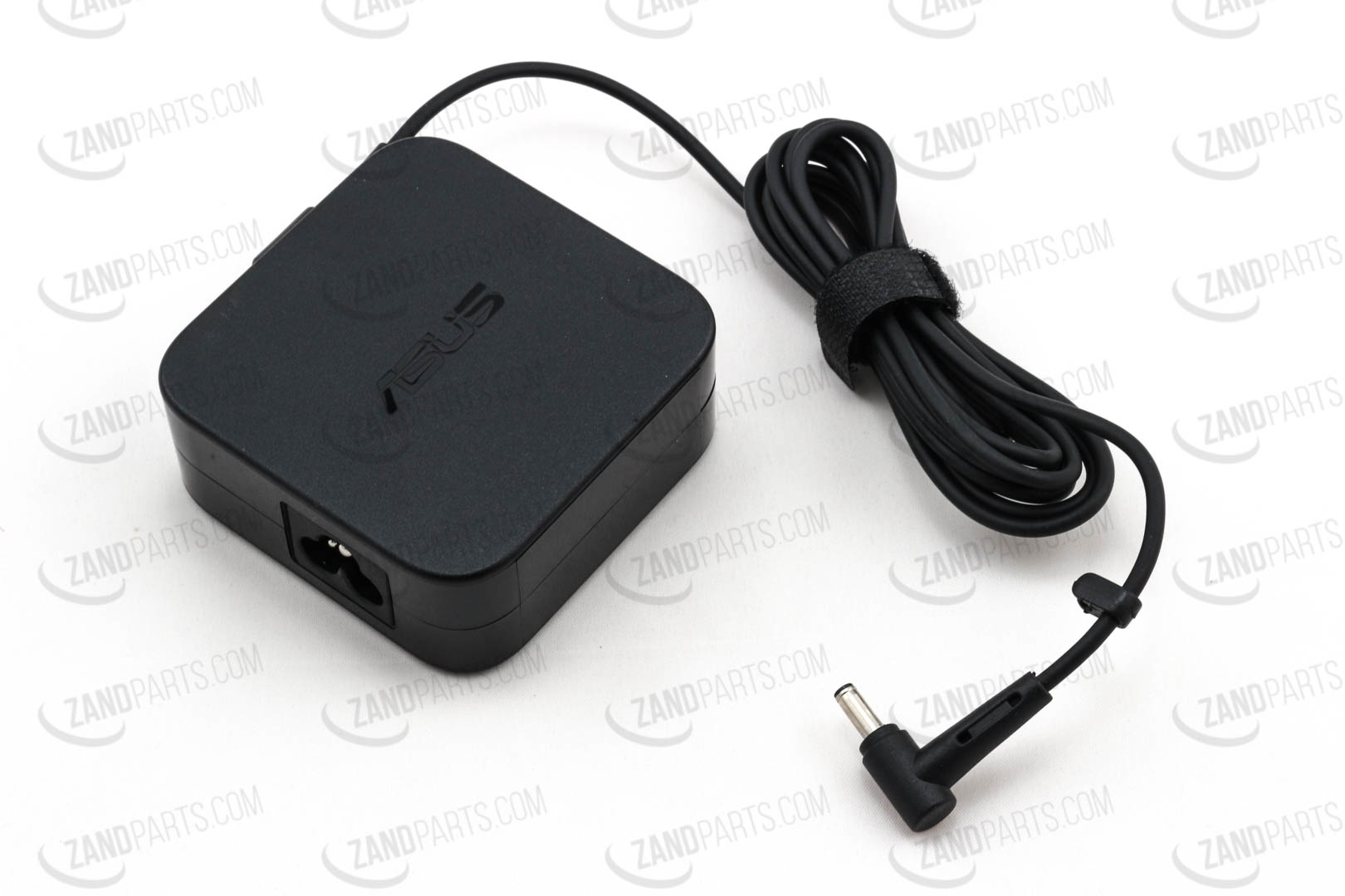 Black ASUS 65W power adapter with a square design, featuring a connector cable and a cylindrical plug, designed for indoor use.