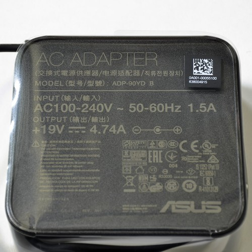 Black ASUS 90W power adapter with model number ADP-90YD B, featuring input/output specifications and a QR code on the surface.