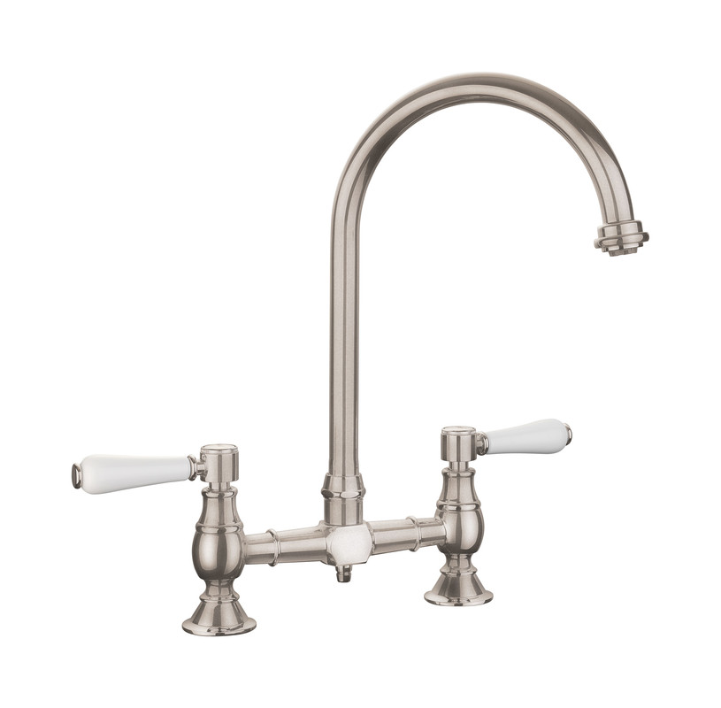 Brushed stainless steel dual lever bridge tap with white ceramic handles and a high arched spout, featuring a classic design suitable for traditional kitchens.