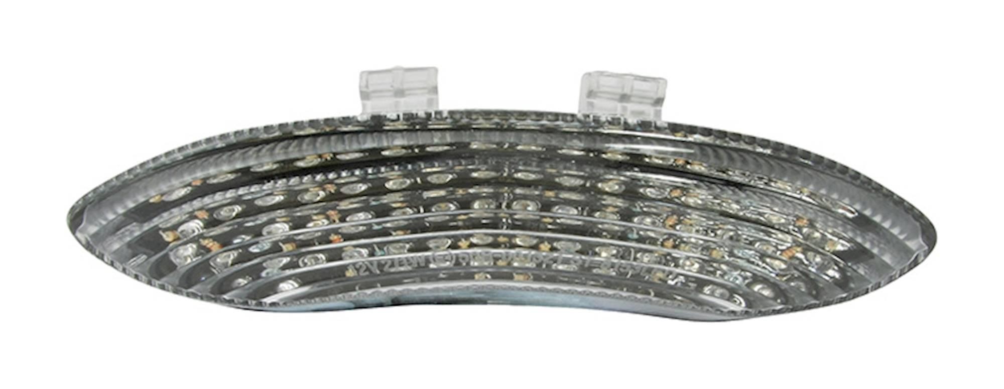 LED rear tail light with a clear lens featuring integral indicators, designed for Triumph Daytona 675 (2006-07), showcasing a sleek, curved shape and multiple light segments.