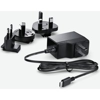 Black Blackmagic Design power adapter with USB-C cable and multiple plug attachments for international use.