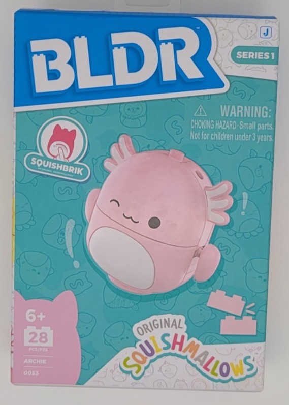 Pink axolotl-shaped construction set box featuring "Archie" from Squishmallows, with a warning label and colorful background, showcasing 28 pieces for ages 6 and up.
