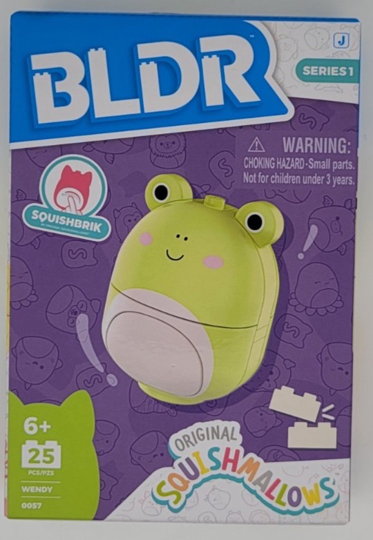 Green frog-shaped construction set featuring a smiling face, large eyes, and a rounded body, packaged in a colorful box with the BLDR logo and warning label.