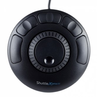 Black circular device with a central dial and six surrounding buttons, featuring a textured grip and a cable for connectivity, designed for enhanced control in digital applications.